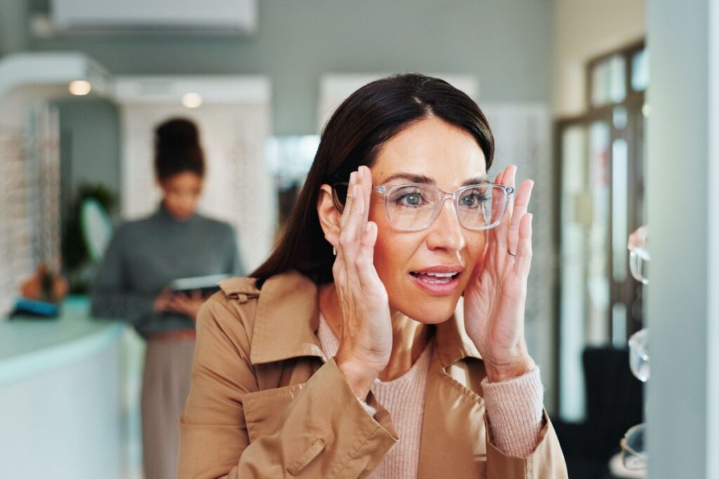 Woman trying on glasses at optometrist office